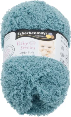A ball of teal yarn with a label showing brand and product information, including a picture of a baby.