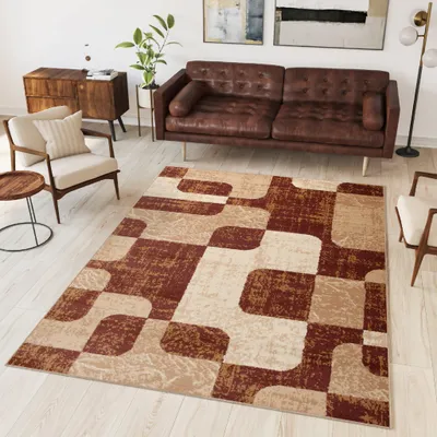 A living room scene with a sofa, armchair, side table, and a rug.