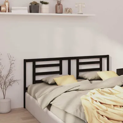 A bedroom scene with a bed and a headboard.