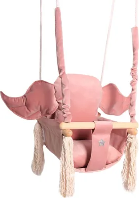 A pink velvet baby swing with wings and tassels, suspended by ropes.