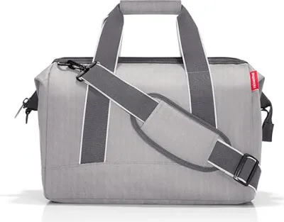 A studio shot of a grey duffel bag.