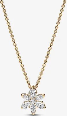 A gold necklace with a flower-shaped pendant made of clear stones, set against a white background.