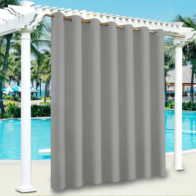 Outdoor curtains hanging on a pergola next to a swimming pool.