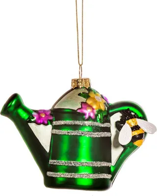 A green glass watering can ornament with flowers and a bee.