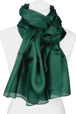 A green silk scarf is draped around a mannequin.
