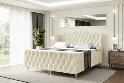 A bedroom scene with a large tufted bed as the main focus.