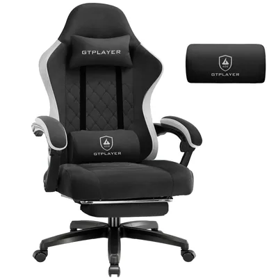 A gaming chair with included pillows, shown from a front-diagonal angle against a white background.