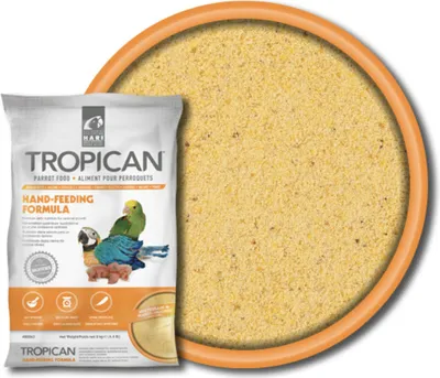 A bag of Tropican Hand Feeding Formula is shown next to a bowl filled with the product.