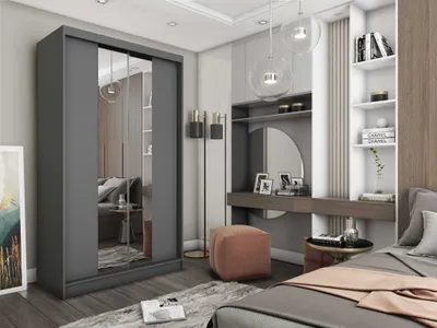 A bedroom scene featuring a large wardrobe, a vanity area with a mirror, and a bed.