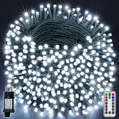 A bundle of white LED string lights coiled together, with a power adapter and a remote control visible.