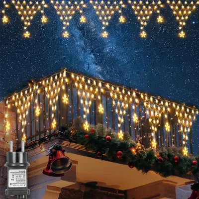 Christmas lights are decorating a balcony and roofline against a starry night sky.