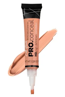 A tube of L.A. Girl Pro Conceal HD Concealer in a peach shade, with a swatch of the product next to it.