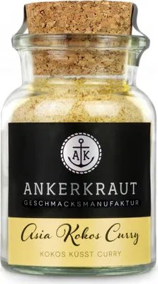 A glass jar containing a yellow spice blend, sealed with a cork.