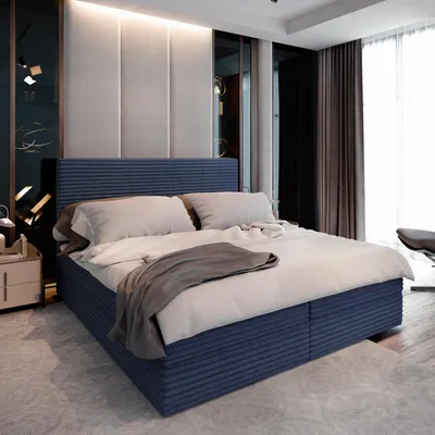A bedroom scene with a large bed as the focal point.
