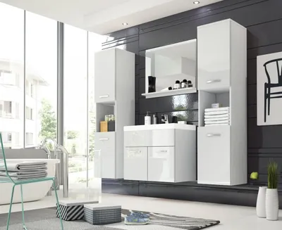 A modern, glossy white bathroom vanity set with tall cabinets and a mirror, set against a dark tiled wall and a large window overlooking a residential area.