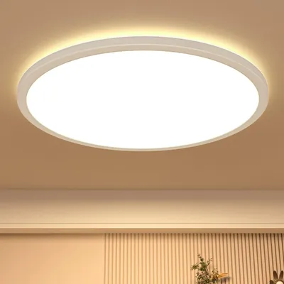 A round, white LED ceiling light is shown mounted on a light beige ceiling.