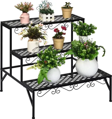 A black metal plant stand with three tiers, displaying various potted plants.