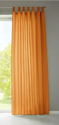 A single orange curtain hanging in front of a window.