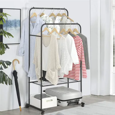 A black metal garment rack with clothes hanging on it, a suitcase, and a storage box on the bottom shelf.