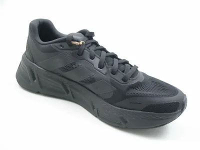A studio shot of a single black Adidas running shoe against a white background.