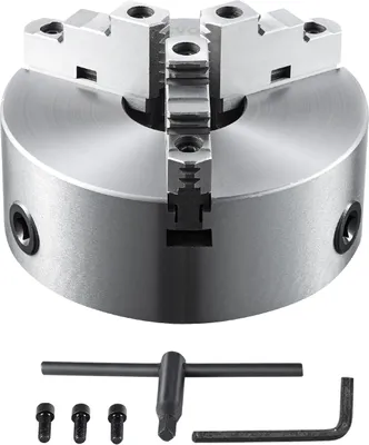 A metal three-jaw chuck with a chuck key and screws on a light gray background.