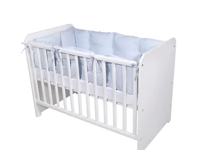 A white baby crib with blue padding inside.