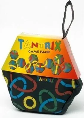 A hexagonal box with a colorful gradient top and a black fabric pouch bottom, both decorated with game pieces and patterns.