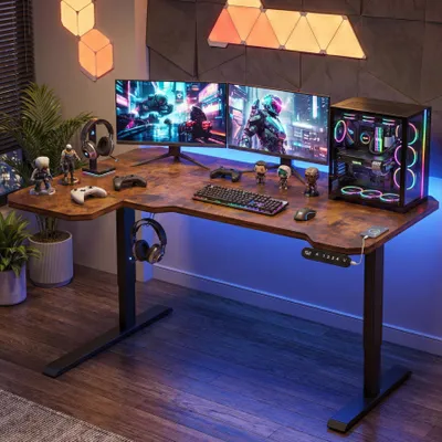 A gaming desk setup with multiple monitors, a computer tower, and accessories, illuminated by LED lighting.