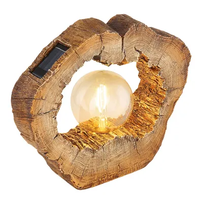 A solar-powered LED lamp designed to look like a slice of wood with a light bulb inside.