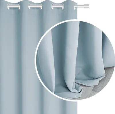 A close-up view of a light blue curtain, showing its texture and how it drapes.