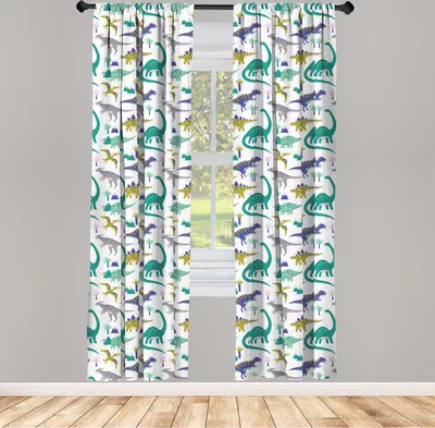 Two curtains with a dinosaur pattern are hanging in front of a window.