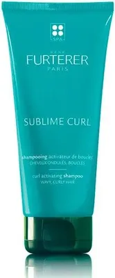 A product shot of a teal colored tube of shampoo.