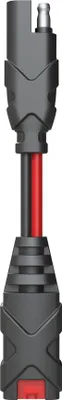 A close-up, studio shot of a black and red electrical adapter with a silver connector at the top.