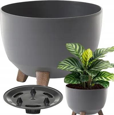 A large grey planter with wooden legs is shown next to a smaller grey planter with a plant in it. A drainage insert is also visible.