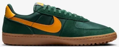 A side view of a green and yellow Nike sneaker with a brown sole.