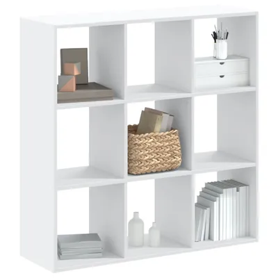 A white cube-shaped bookshelf with various items on its shelves.