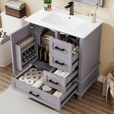 A bathroom vanity with the doors and drawers open, showing storage compartments.
