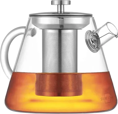 A glass teapot with a metal infuser and tea inside, presented on a white background.