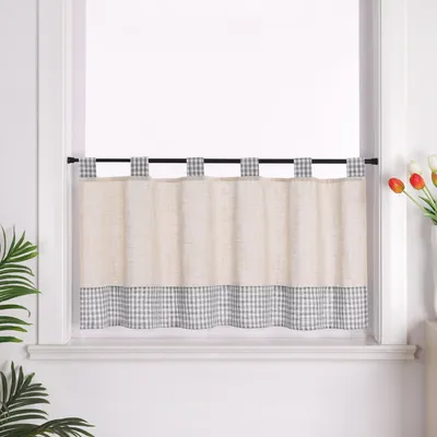 A kitchen window with a cafe curtain.