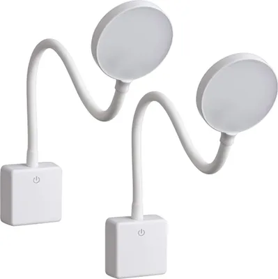 Two white LED plug-in lamps with flexible goosenecks and round light heads are shown against a white background.