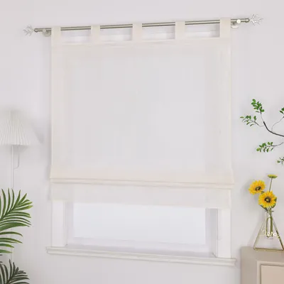 A white Roman blind hangs on a window, with a lamp and plants visible to the left and right.