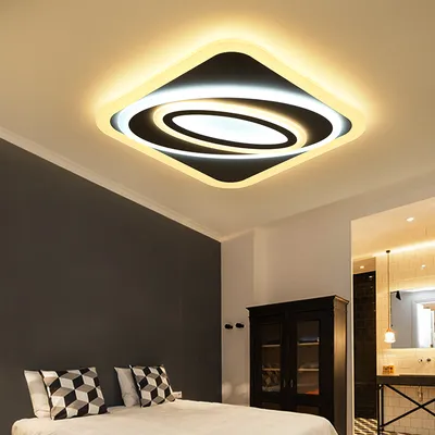 A modern bedroom with a stylish ceiling light.