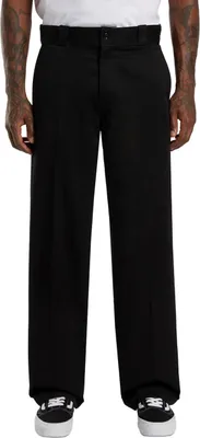 A person wearing black pants and shoes, shown from the waist down.