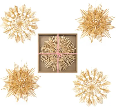 A collage of four straw star ornaments, one of which is in a box with pink ribbon.