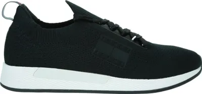 A side view of a single black sneaker with a white sole.