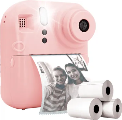 A pink instant camera with a printed photo and several rolls of photo paper.