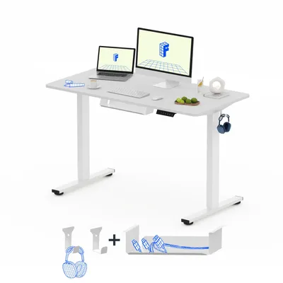 A white electric standing desk with a laptop, monitor, and accessories on a white background.