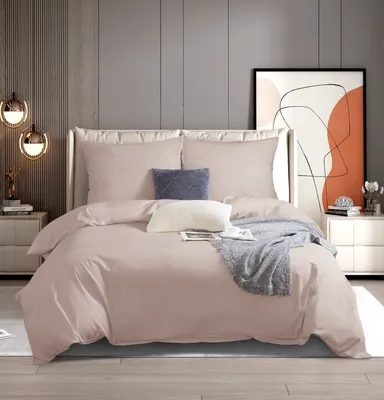 A neatly made bed with pink bedding in a modern bedroom setting.