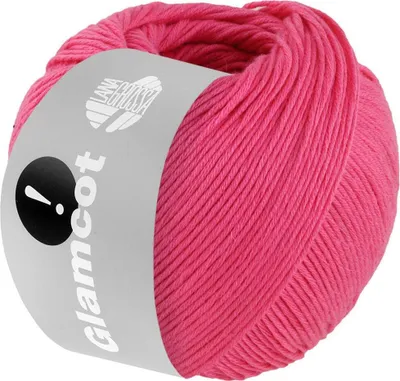 A ball of pink yarn with a label wrapped around it.