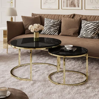 A living room scene with a sofa, coffee tables, and decorative items.